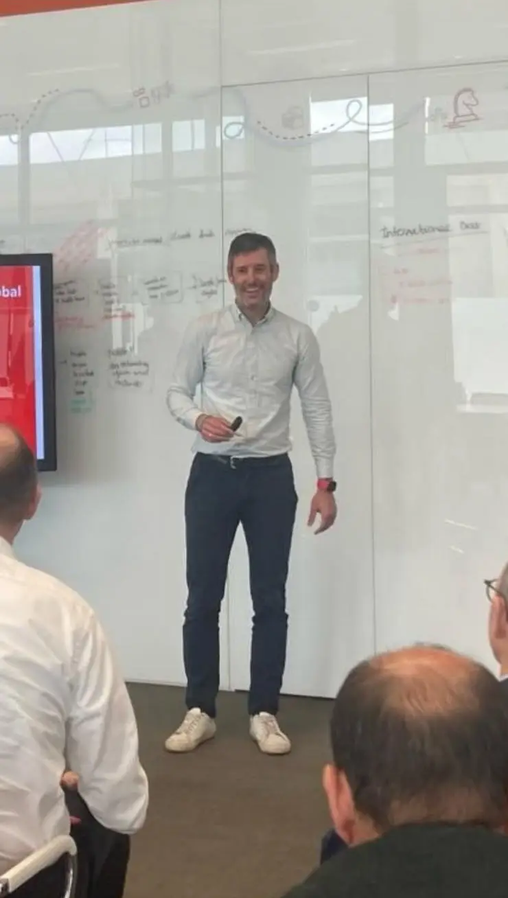 Charly Vaquero presentando ante un grupo, en un entorno corporativo